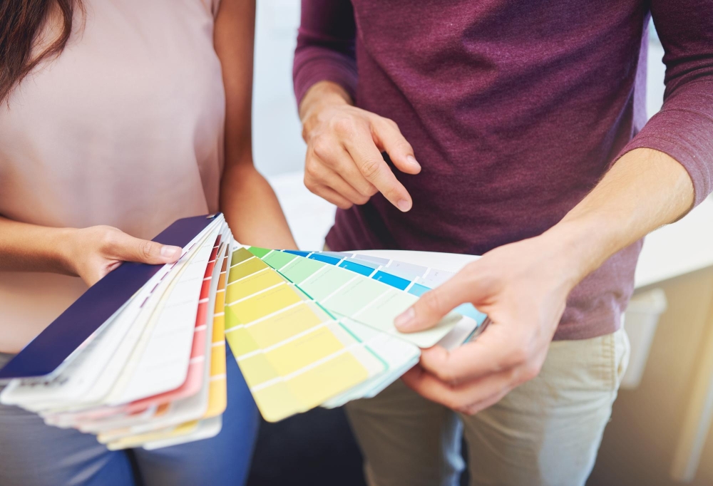 Professional painter showing color swatches to customer